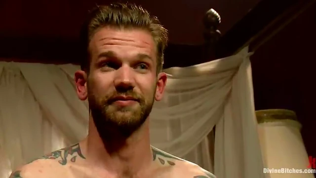 Mistress Madeline Straps on Tattooed Guy While He Gets Handjob Blissfully