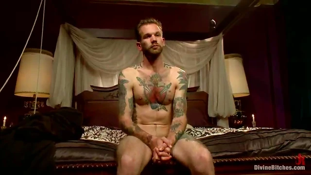 Mistress Madeline Straps on Tattooed Guy While He Gets Handjob Blissfully