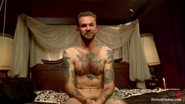 Mistress Madeline Straps on Tattooed Guy While He Gets Handjob Blissfully