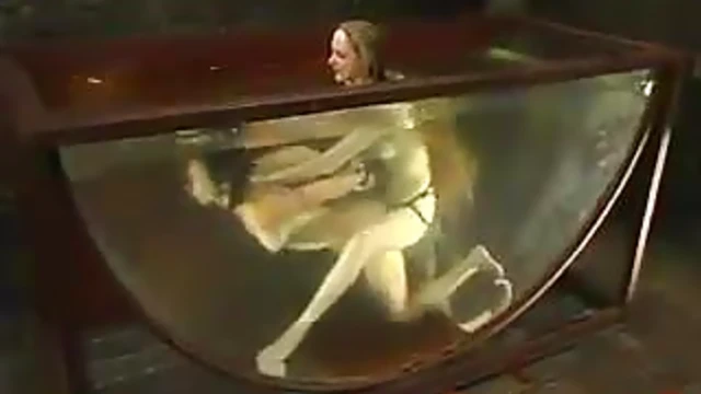 Wenona Submerged in Bathtub during Steamy BDSM Scene