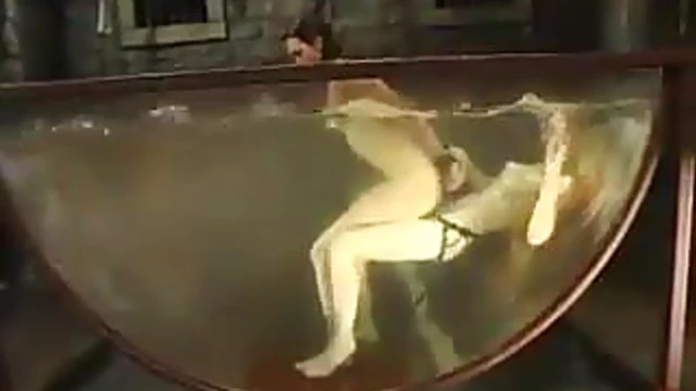 Wenona Submerged in Bathtub during Steamy BDSM Scene