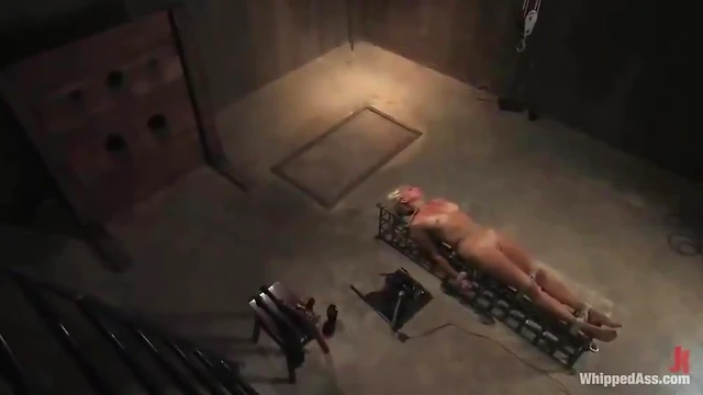 Submissive Blonde in Stocks Gets Hardcore Punishment from Dominant Mistress