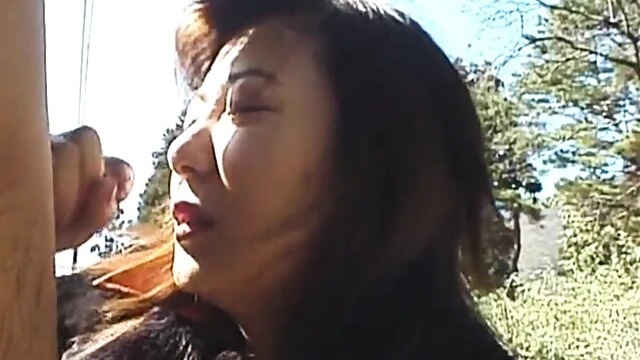 Seductive Japanese Brunette Takes His Cock Outdoors Under Sunny Skies