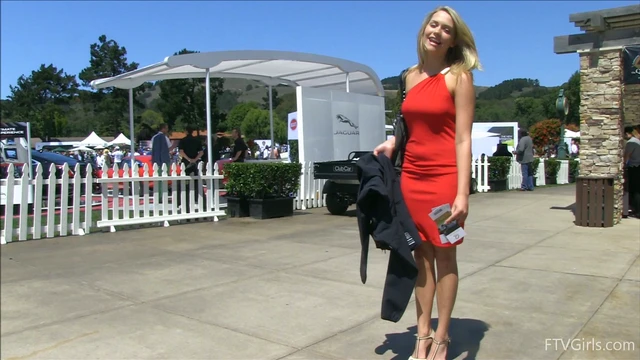 Sultry Solo Model Teases in High Heels Amidst Outdoor Car Show