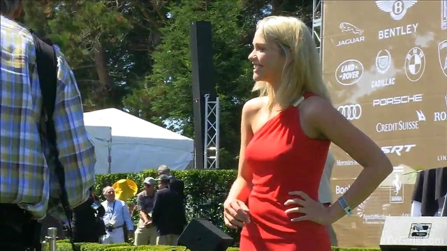 Sultry Solo Model Teases in High Heels Amidst Outdoor Car Show