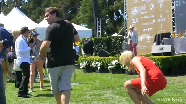 Sultry Solo Model Teases in High Heels Amidst Outdoor Car Show