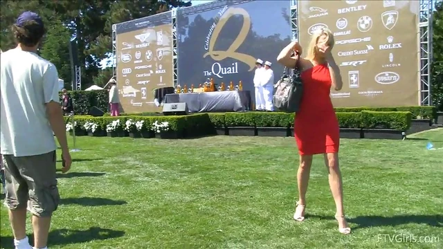 Sultry Solo Model Teases in High Heels Amidst Outdoor Car Show