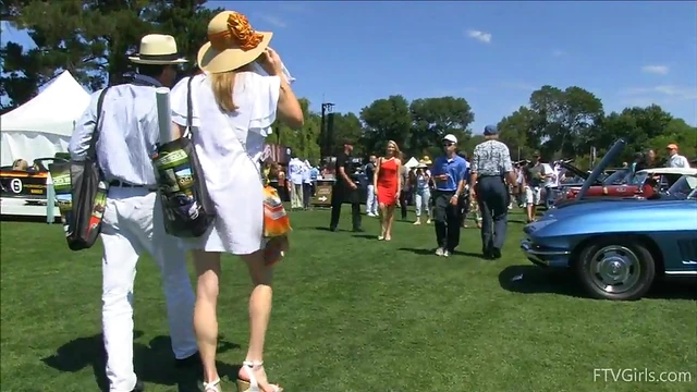 Sultry Solo Model Teases in High Heels Amidst Outdoor Car Show