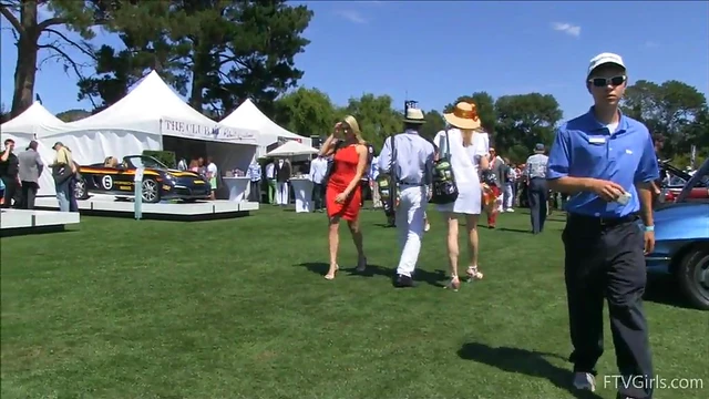 Sultry Solo Model Teases in High Heels Amidst Outdoor Car Show