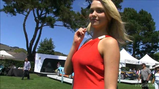 Sultry Solo Model Teases in High Heels Amidst Outdoor Car Show