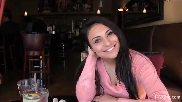 Sexy Babe Rikki Displays Her Busty Curves Over the Table Seductively