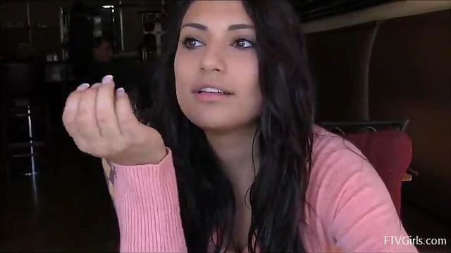 Sexy Babe Rikki Displays Her Busty Curves Over the Table Seductively