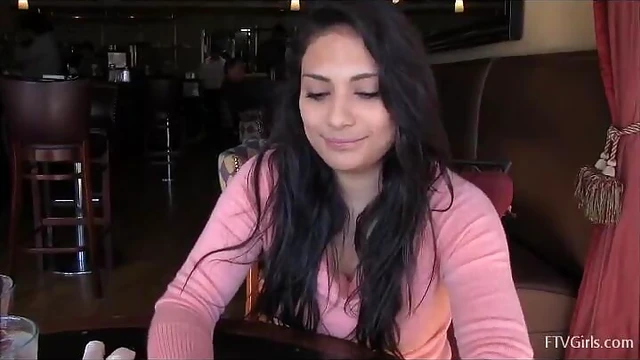 Sexy Babe Rikki Displays Her Busty Curves Over the Table Seductively