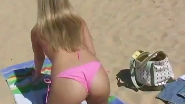 Blonde Beauty in Pink Bikini Sunbathing Sensually by Ocean Waves