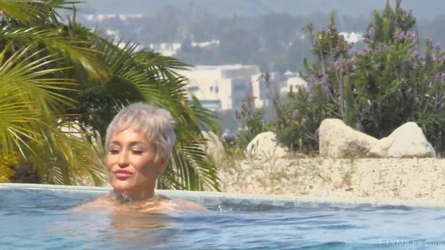 Ryan Strips By The Pool Exposing Her Shaved MILF Pussy Publicly