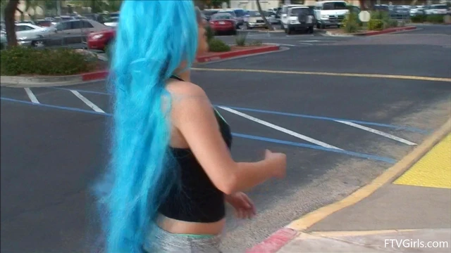 Seductive Stacey in Blue Wig Strips Teasingly By The Poolside