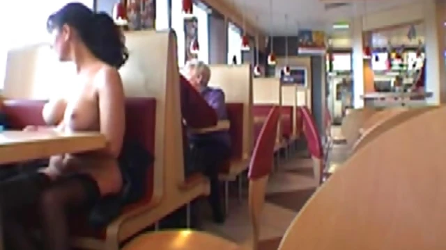 Sexy Brunette Shows Off Her Boobs at Busy Restaurant Table