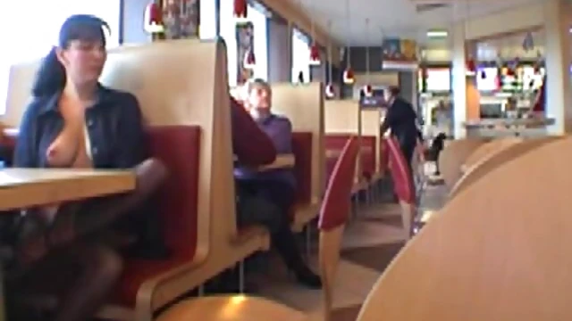 Sexy Brunette Shows Off Her Boobs at Busy Restaurant Table