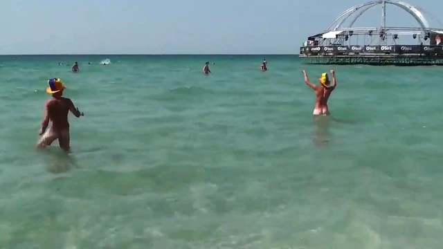 Young Girl Enjoys Beach Party With Sexy Guys In The Sunlight