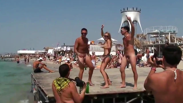 Young Girl Enjoys Beach Party With Sexy Guys In The Sunlight