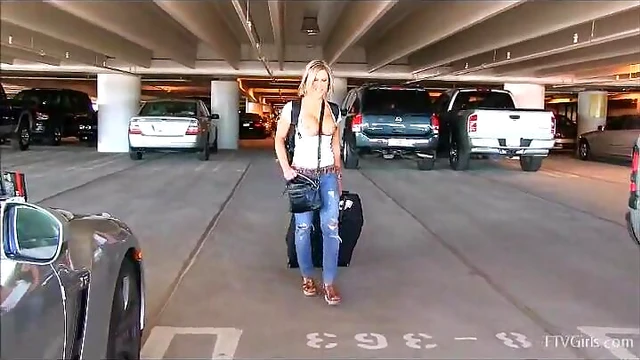 Sizzling Blonde Displays Stunning Tits at Busy Airport Lot