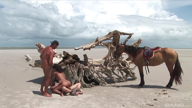 Sexy Brunette Takes Two Dicks While Sunbathing by the Beach Sands